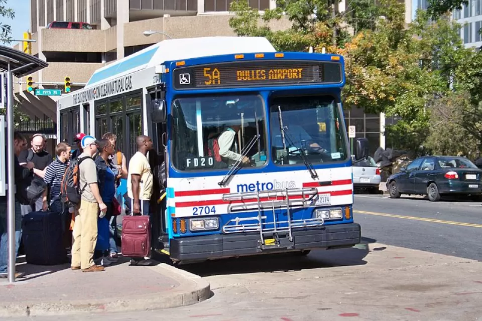 Passengers lined up to board city bus in Washington, D.C. to Dulles Airport